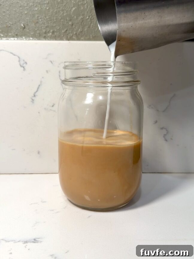 Banana Bread Latte Syrup Recipe — Homemade Coffee Flavoring 2 finishing a banana bread latte with milk