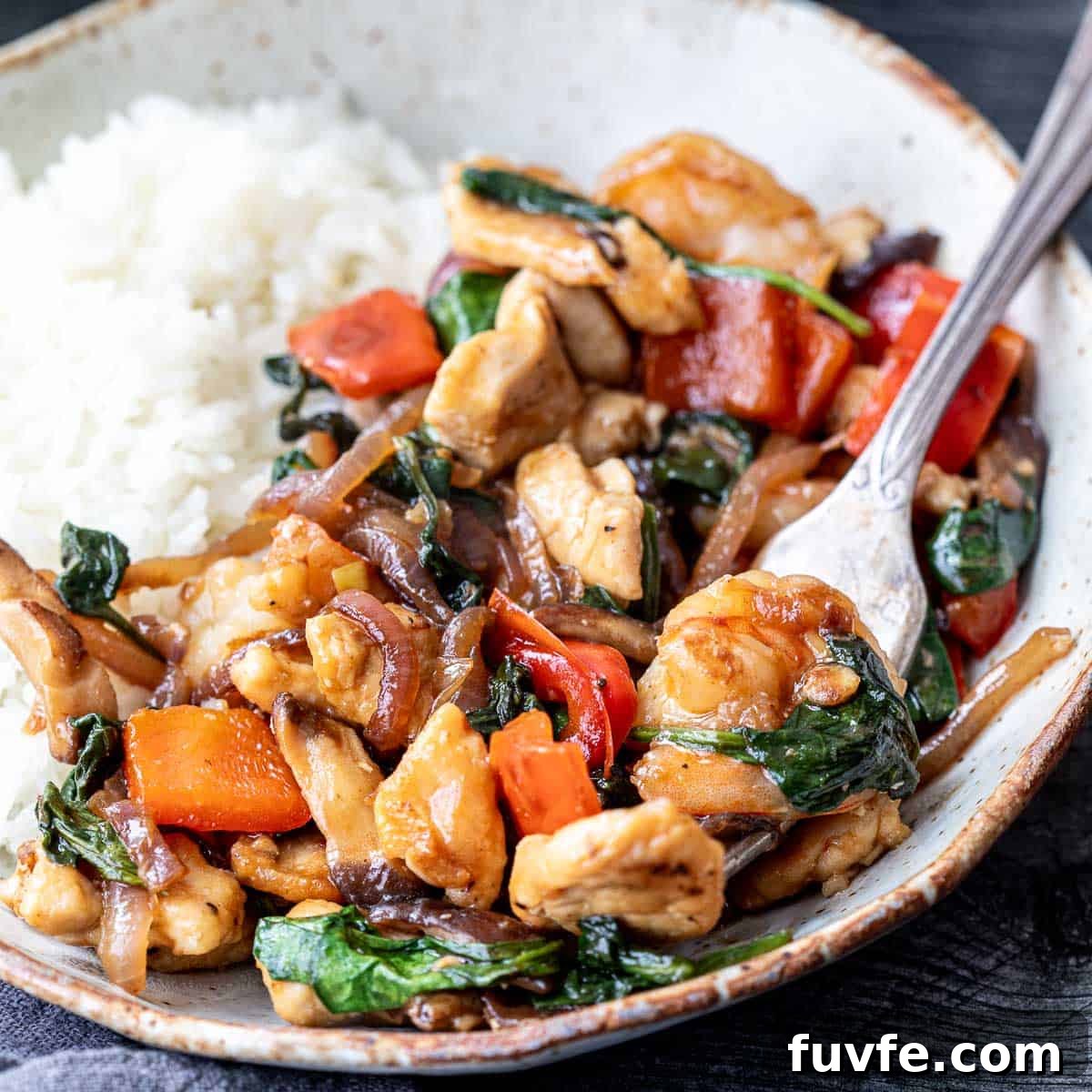 shrimp and chicken stir fry on plate.