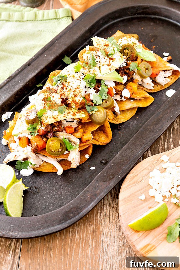 Chicken and Chorizo Enchiladas: From Aztec Roots to Tex‑Mex Favorites 2 A long black platter of chicken and chorizo enchiladas.