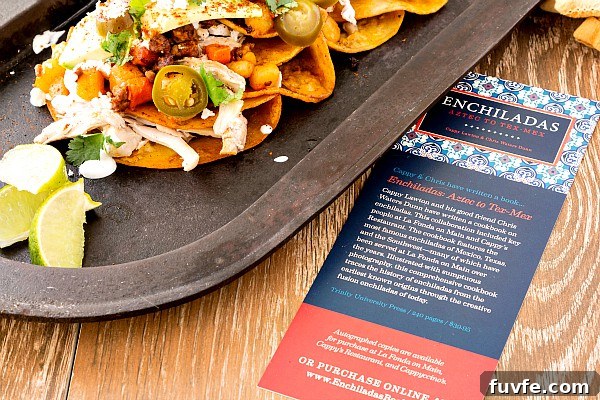 Chicken and Chorizo Enchiladas: From Aztec Roots to Tex‑Mex Favorites 6 Enchiladas with a printed sheet of paper about the book Enchiladas: Aztec to Tex Mex.