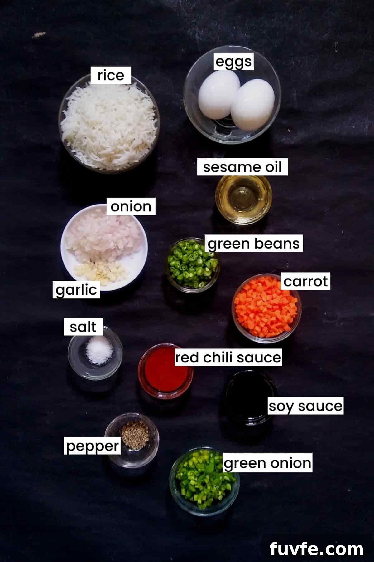 Image showing egg fried rice recipe ingredients on a black background.