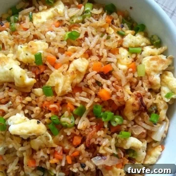 Close up image showing egg fried rice in a bowl.