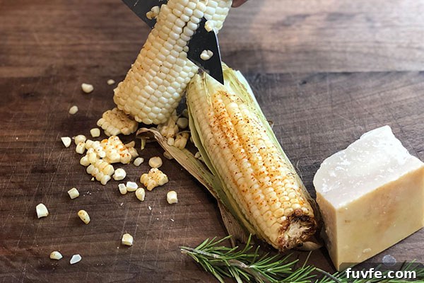 Spicy Sweet Corn Polenta Recipe — Creamy, Savory, Zesty 3 cutting grilled corn off the cob