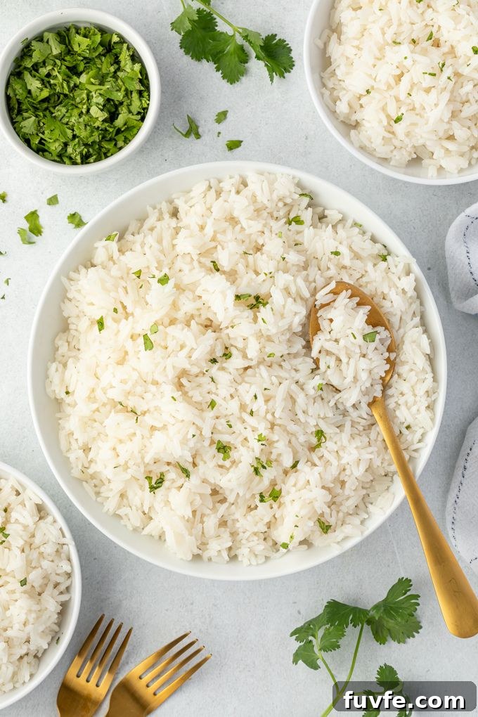 How to Make Coconut Rice (Creamy Jasmine Rice) 3 Coconut milk rice in a bowl with a serving spoon