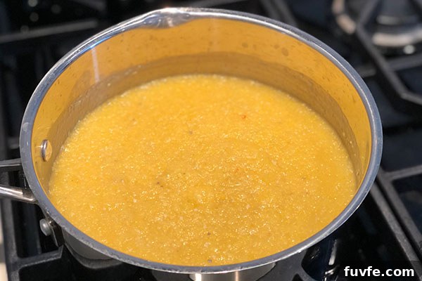 Spicy Sweet Corn Polenta Recipe — Creamy, Savory, Zesty 4 corn polenta cooking in pan