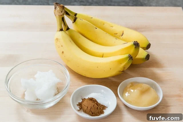 Caramelized Honey Pan-Fried Bananas Recipe 3 Bananas, coconut oil, cinnamon, salt, and honey on a wooden board