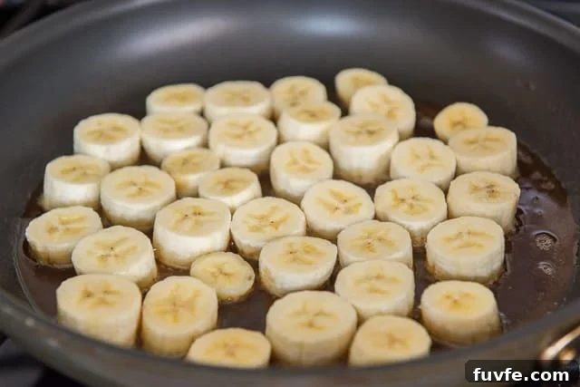 Caramelized Honey Pan-Fried Bananas Recipe 6 Banana slices in skillet with honey mixture
