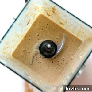A brown liquid in a blender resembling an apple pie smoothie.