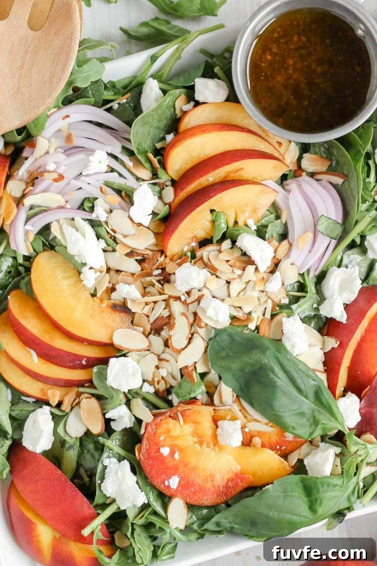Mixed greens topped with sliced peaches, slivered almonds, red onion slices, goat cheese crumbles with a side of vinaigrette dressing.