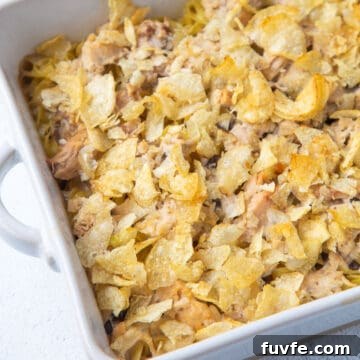tuna noodle casserole with potato chips in a white dish.