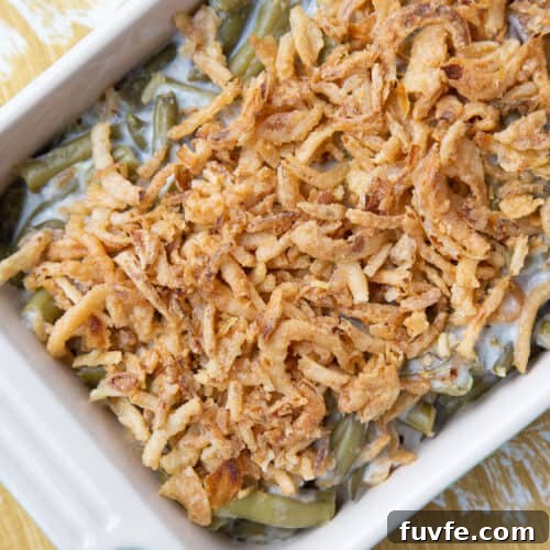 green bean casserole topped with fried onions in a casserole dish.