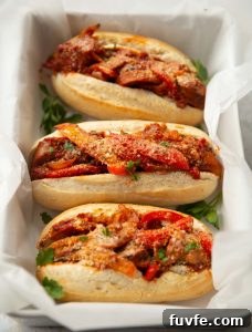 3 sandwiches in large dish with white parchment paper