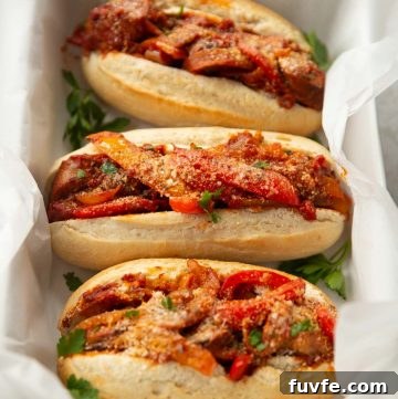 3 sandwiches in large dish with white parchment paper