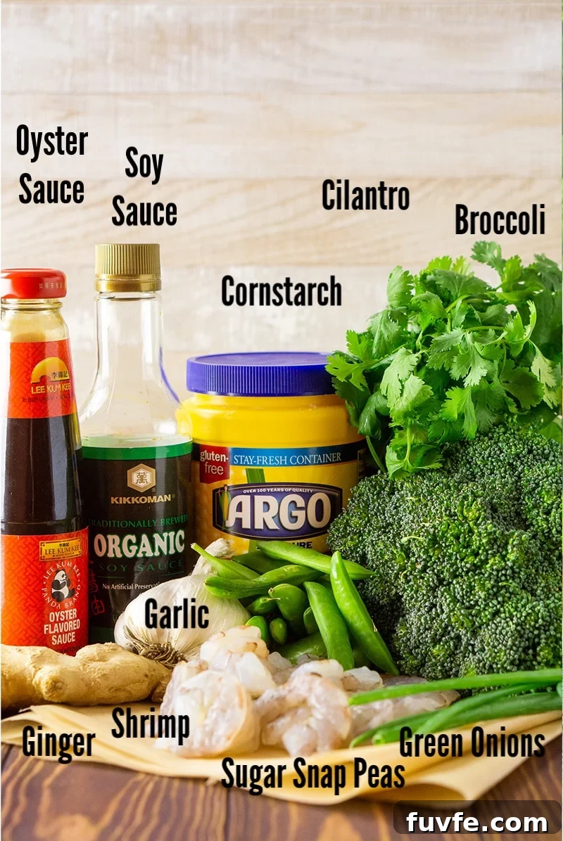 Oyster sauce, soy sauce, cornstarch, cilantro, broccoli, ginger, garlic shrimp and sugar snap peas on a counter.