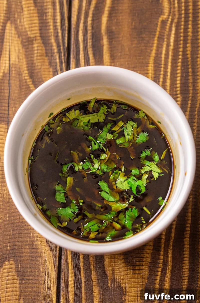 Stir fry sauce in a bowl topped with fresh chopped cilantro.