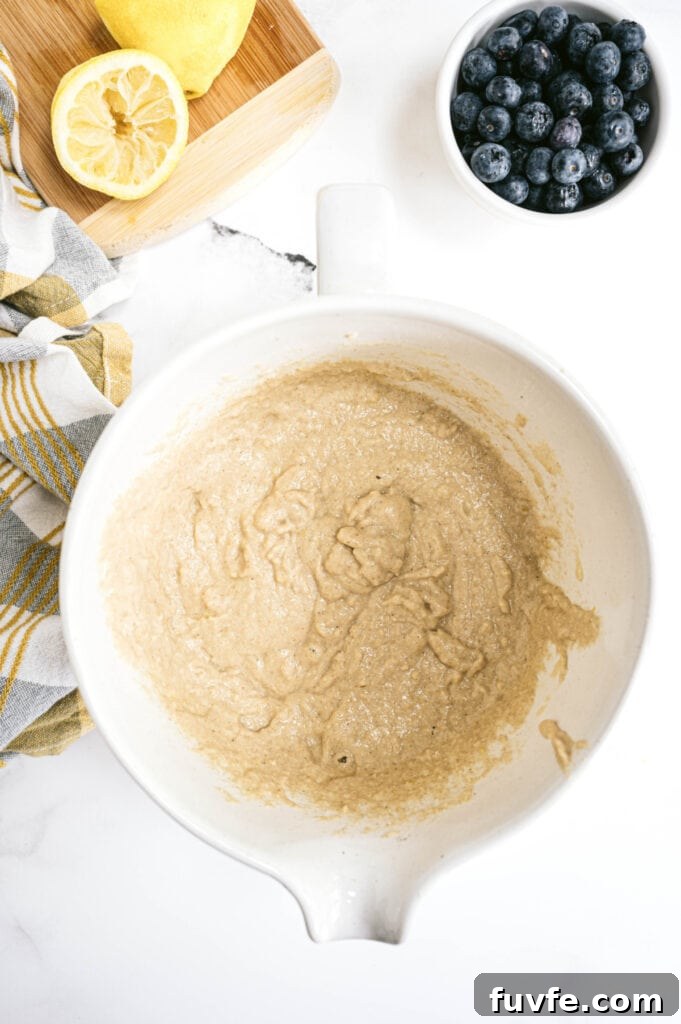 Lemon Blueberry Quick Bread Recipe for Moist Zesty Loaves 4 Overhead image of batter for the lemon blueberry bread, lemon, and blueberries