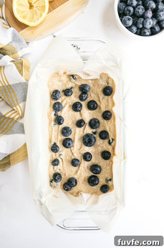 Lemon Blueberry Quick Bread Recipe for Moist Zesty Loaves 5 Overhead photo of lemon blueberry batter in a loaf pan