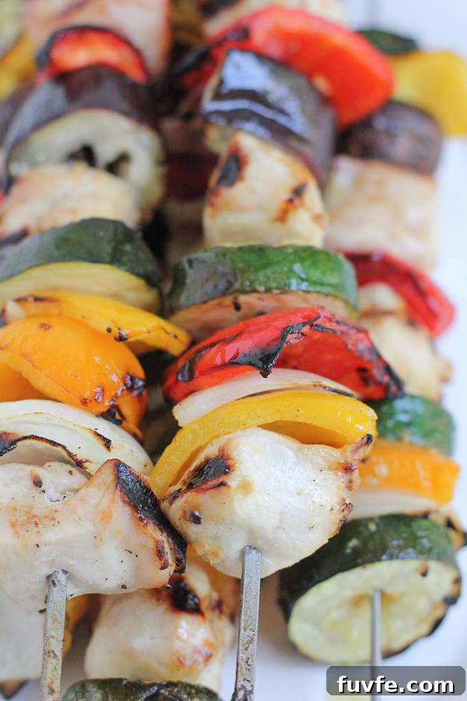 Grilled Chicken Kebabs on a white platter.