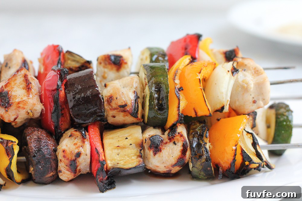 Grilled Chicken Kebabs on a white platter.