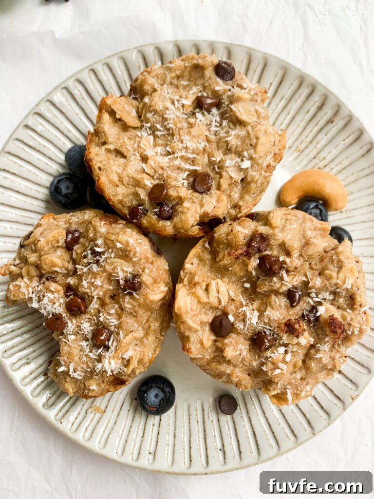 a plate with three oatmeal cups, blueberries, and cashews