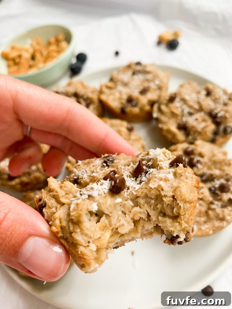 a hand holding one of the oatmeal cups