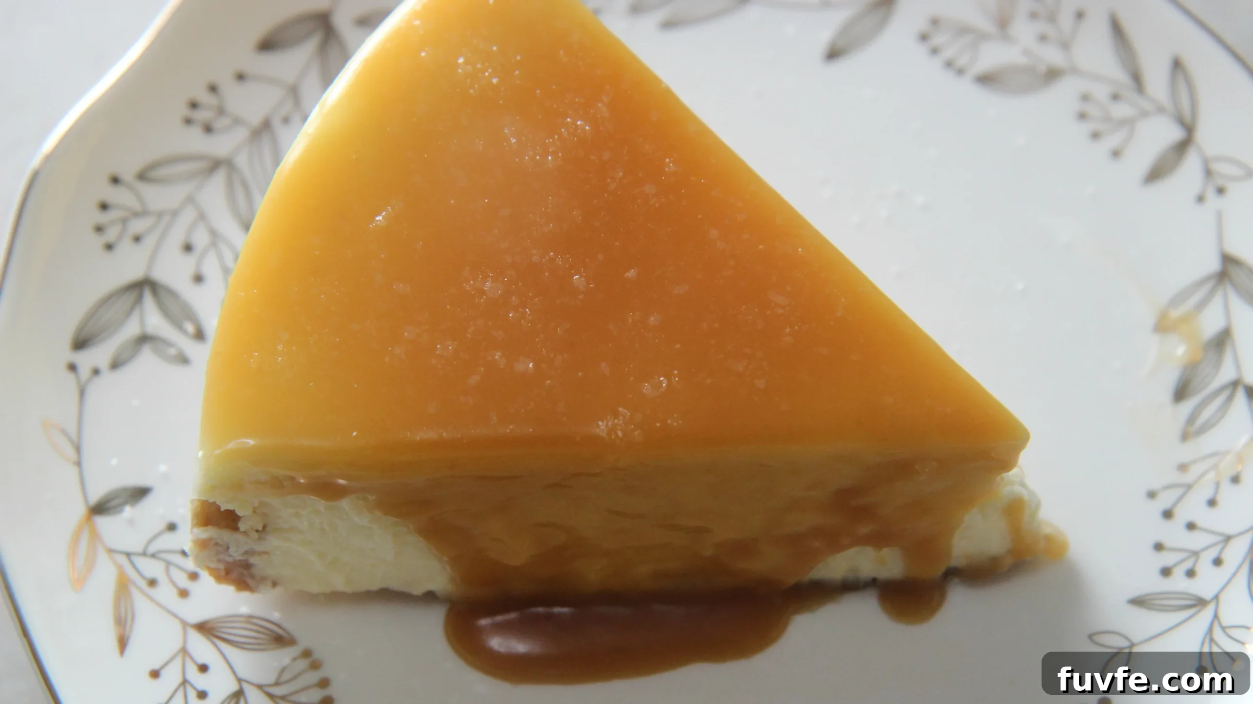 a slice of salted caramel cheesecake on a white plate