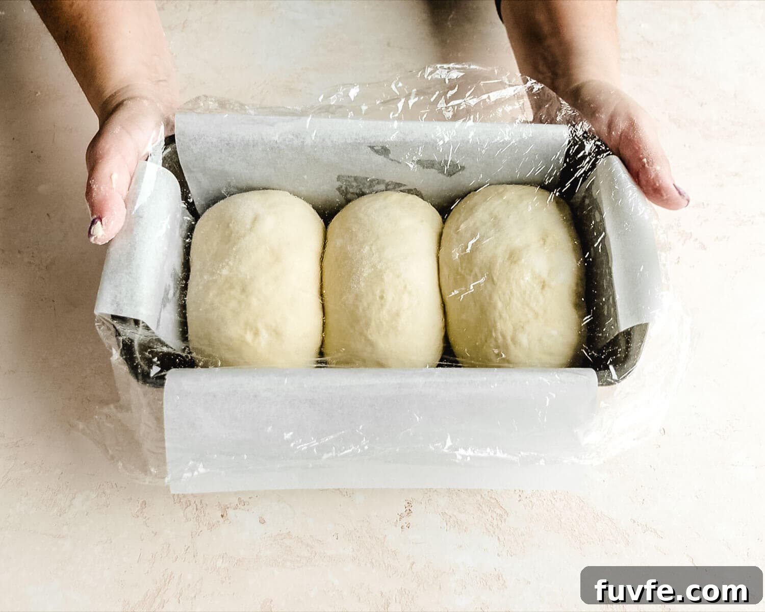 Creamy Condensed Milk Bread Recipe for Soft Homemade Loaf 26 Cover dough with plastic wrap.