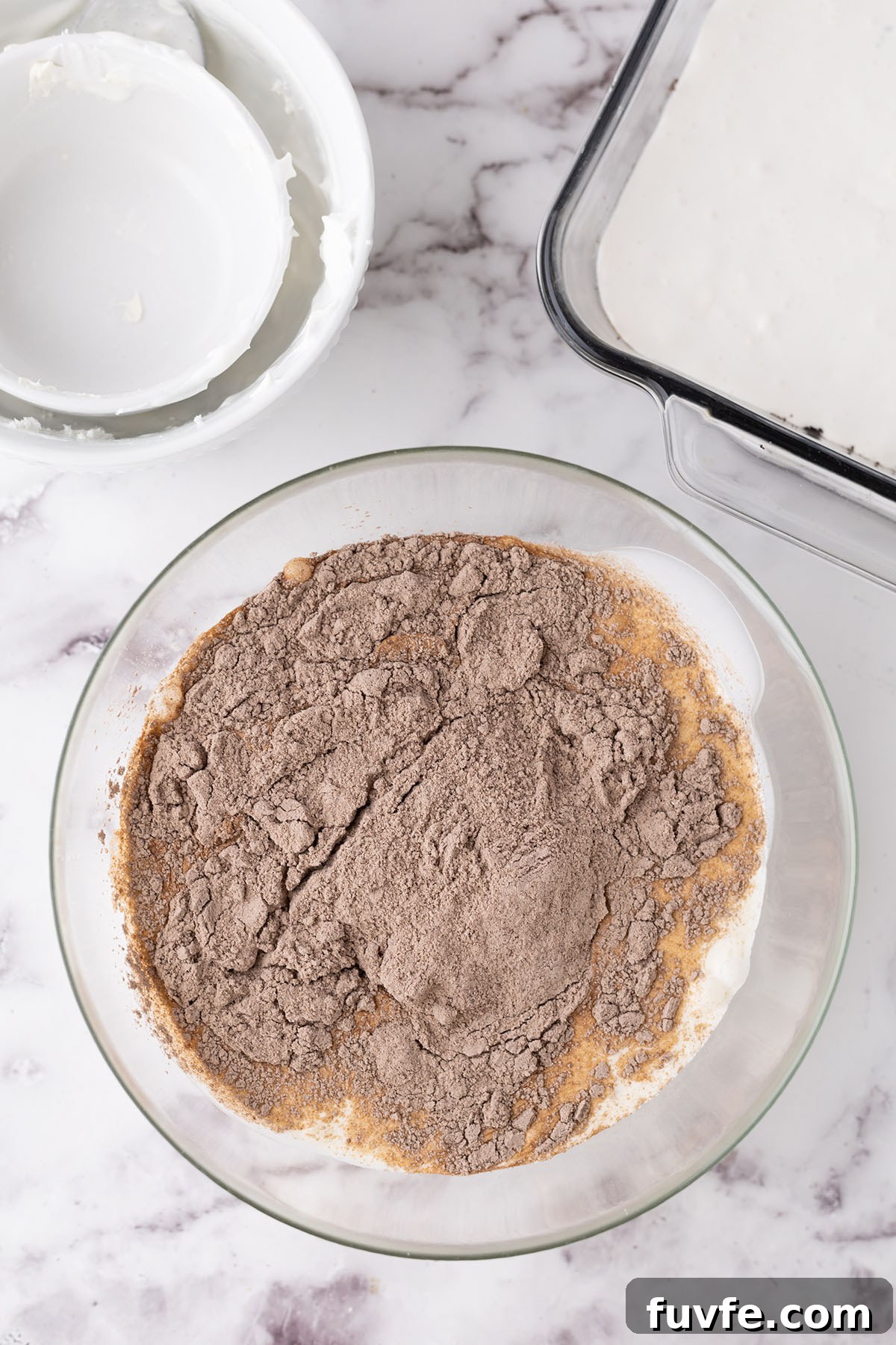 Heavy whipping cream and chocolate pudding mix in a mixing bowl.