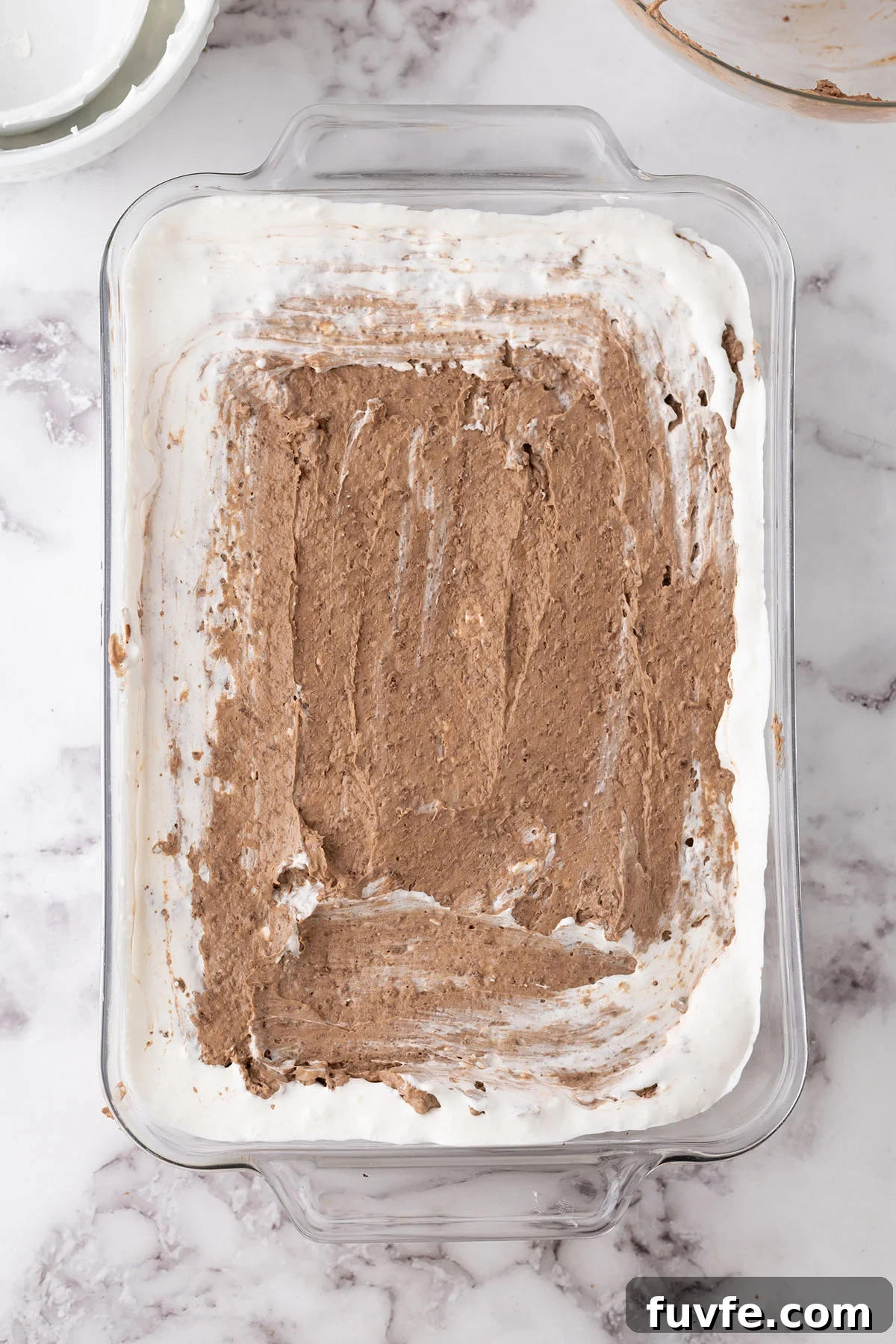 Chocolate pudding layer in a rectangle glass dish.