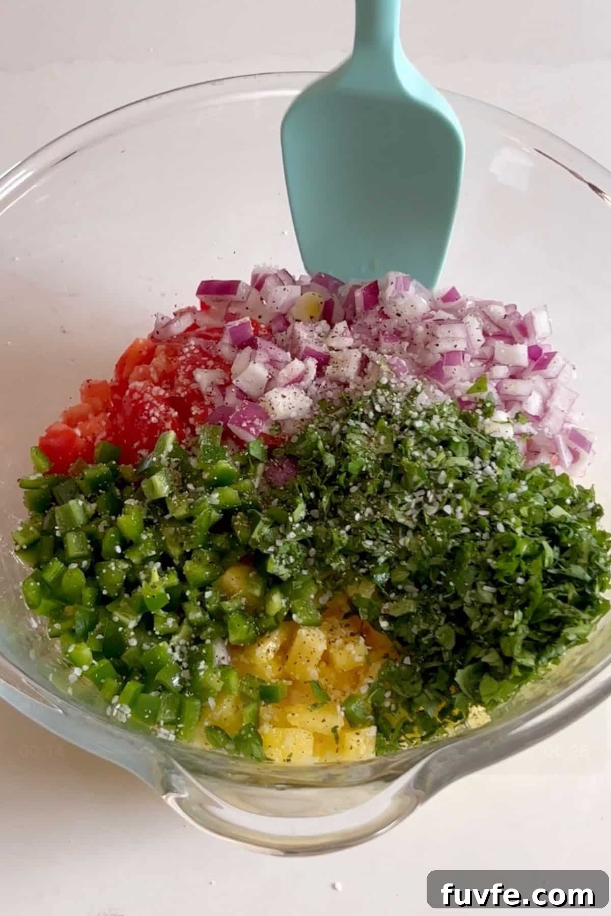 Salsa ingredients in a glass bowl.