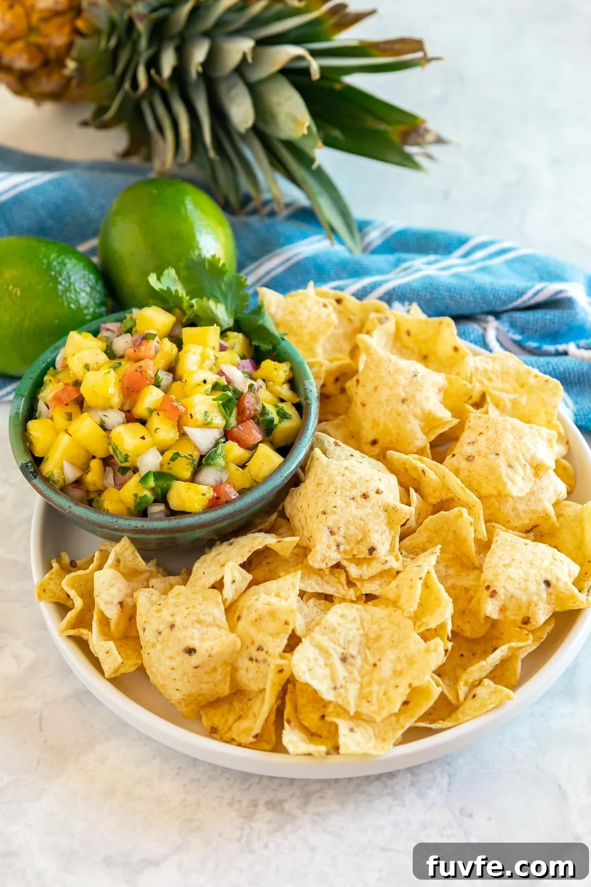 Chips with a bowl of pineapple salsa.