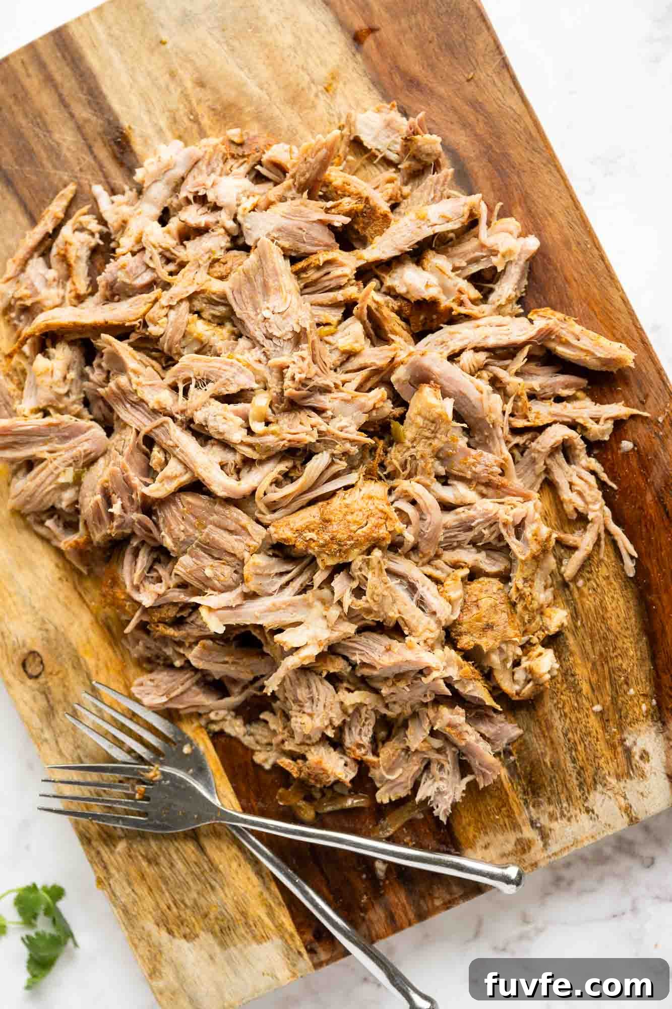 Authentic Instant Pot Carnitas Recipe for Tender Mexican Pork 5 Shredded carnitas on a cutting board