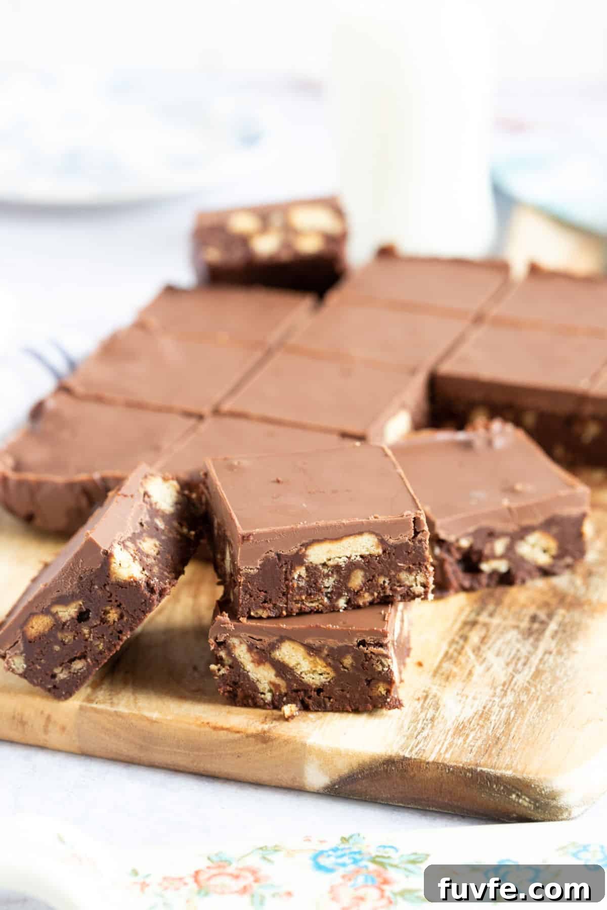 Quick Chocolate Tiffin Recipe: No-Bake Chocolate Biscuit Slice 3 Chocolate tiffin on a wooden board.