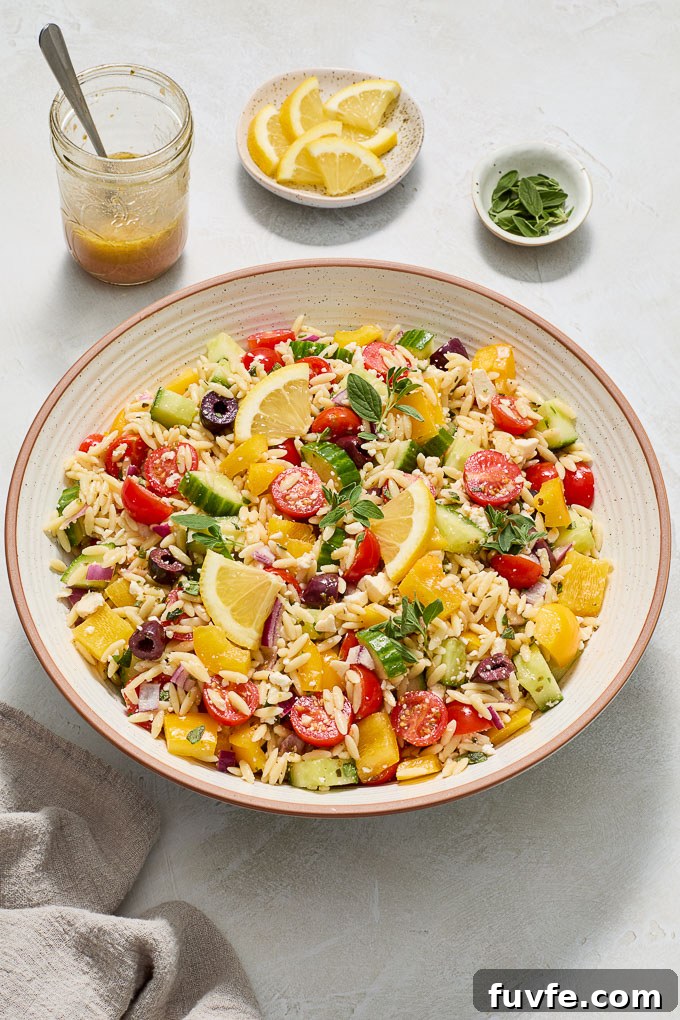 Greek Orzo Salad with Feta, Olives and Lemon Dressing 3 Greek orzo pasta salad in a serving bowl.