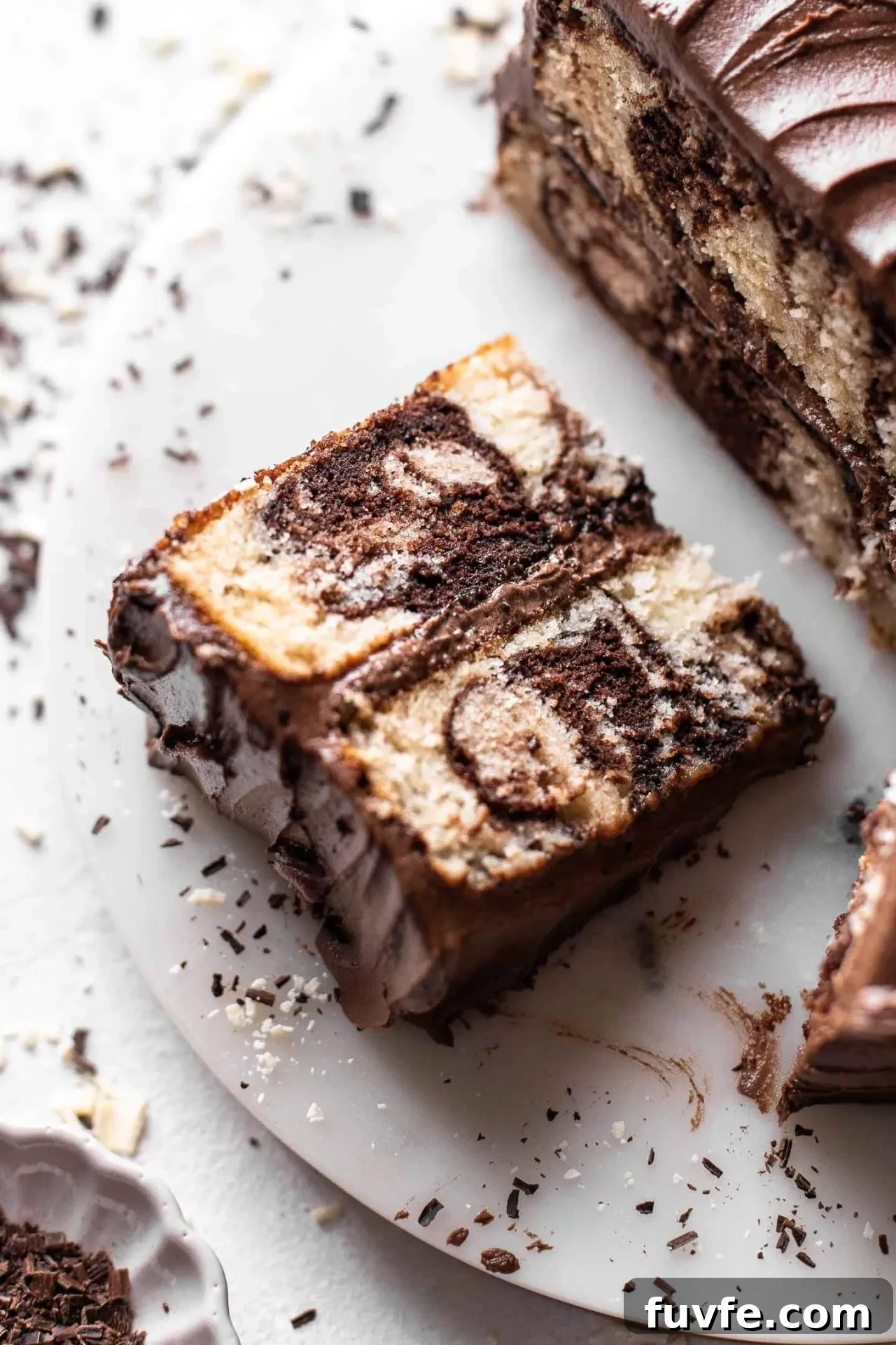 Classic Marble Cake Recipe with Swirled Chocolate-Vanilla Layers 2 sliced marble cake on cake stand