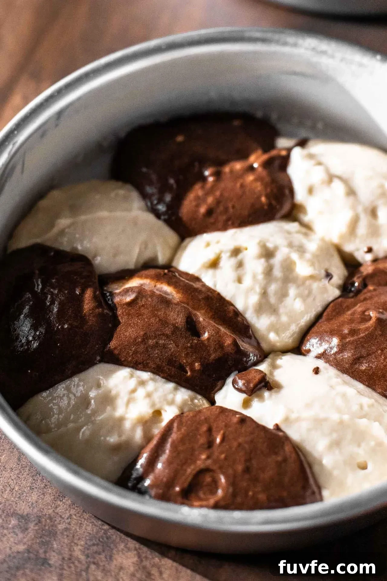Classic Marble Cake Recipe with Swirled Chocolate-Vanilla Layers 9 marble cake alternating dollops of vanilla and chocolate cake batter in cake pan