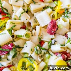 Vegan Antipasti Pasta Salad with Roasted Veggies and Olives 14 A close up of vegan pasta salad with peppers and anti-pasti.