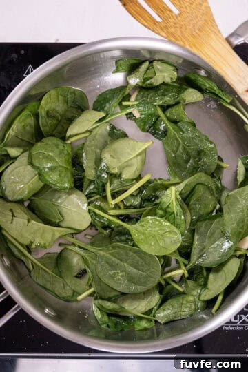 Lemon Spinach Pasta Recipe: Bright 20-Minute Weeknight Meal 7 Sauteing spinach in a pan.