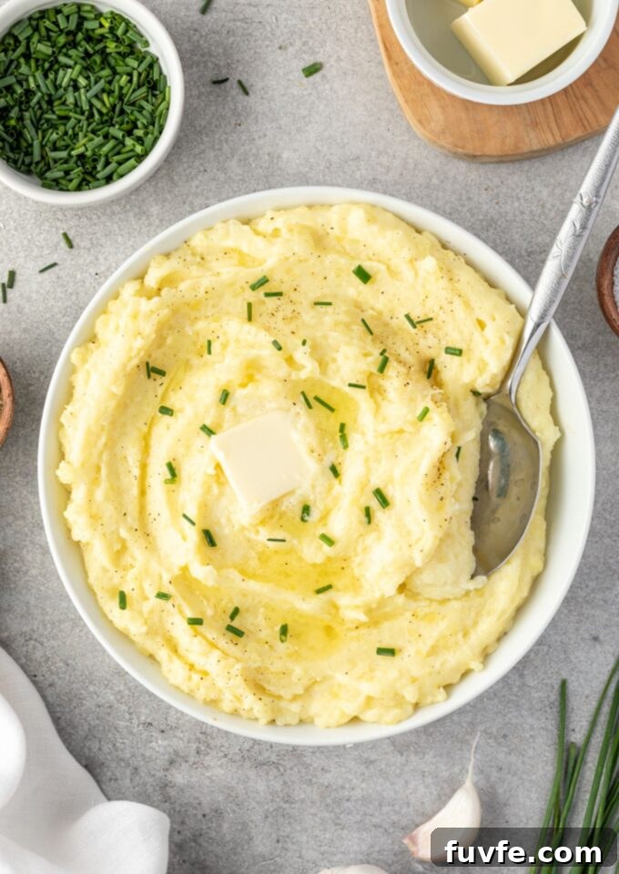 Yukon gold mashed potatoes in a bowl with serving spoon