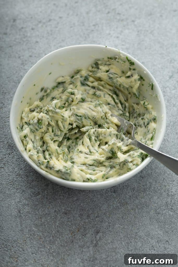 Herb-Butter Roast Chicken Recipe for Juicy Crispy Skin 6 butter, garlic, thyme, rosemary and parsley mixed together in a small white bowl