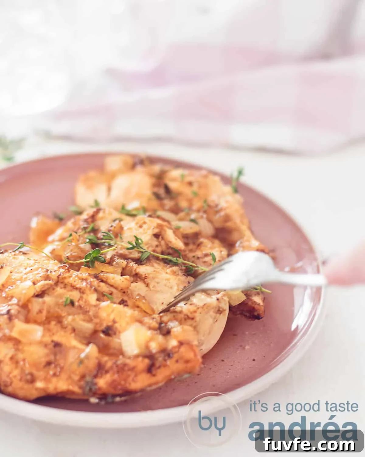 Brown Sugar Garlic Chicken Slow Cooker Recipe for Tender, Sticky Wings 5 An aerial view of a chicken, with a brown sugar marinade and fresh thyme on a pink plate. A white background.