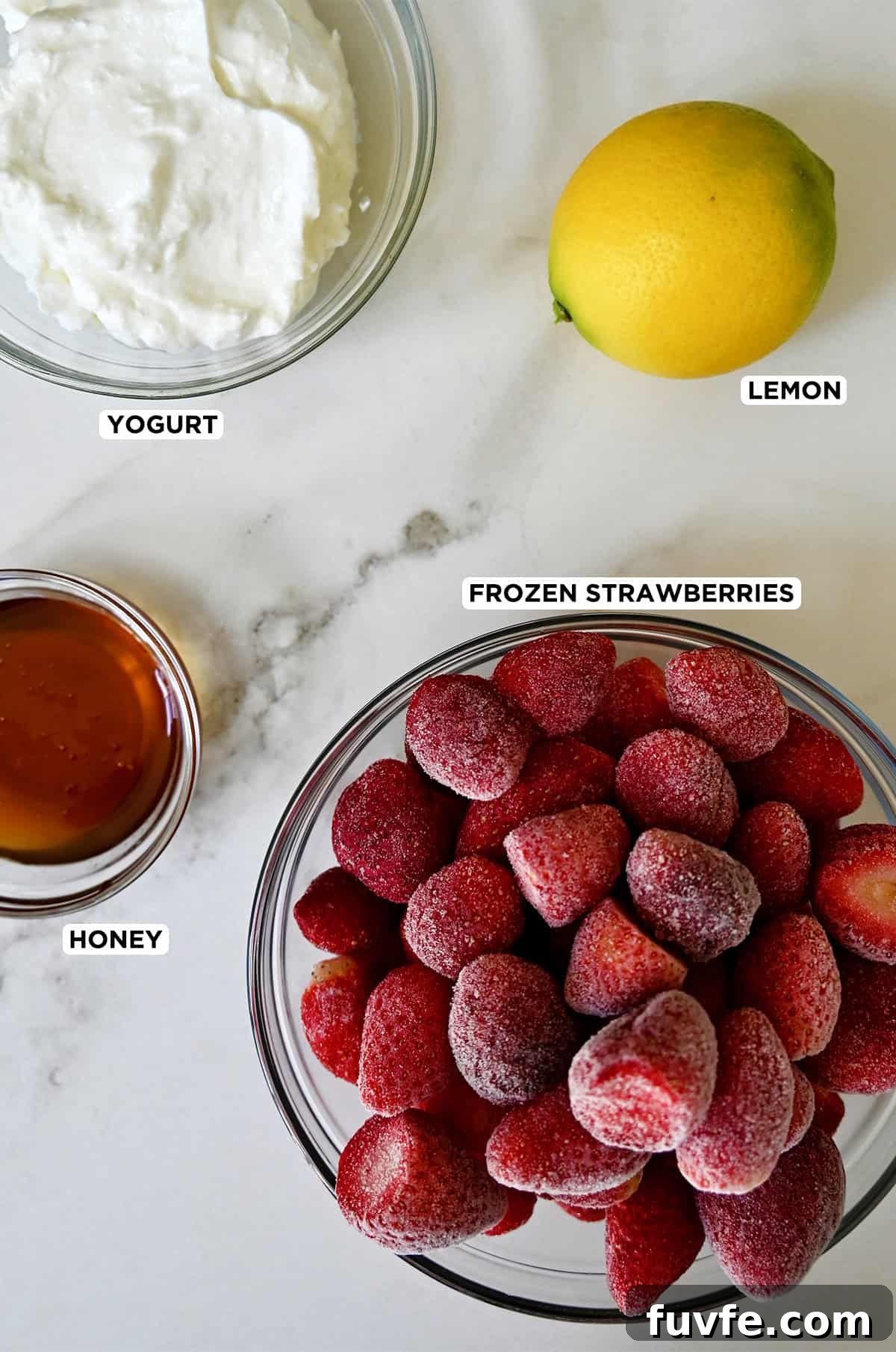 Quick Strawberry Frozen Yogurt Recipe Ready in 5 Minutes 3 Frozen strawberry yogurt ingredients, including plain yogurt, lemon juice, honey and frozen berries.