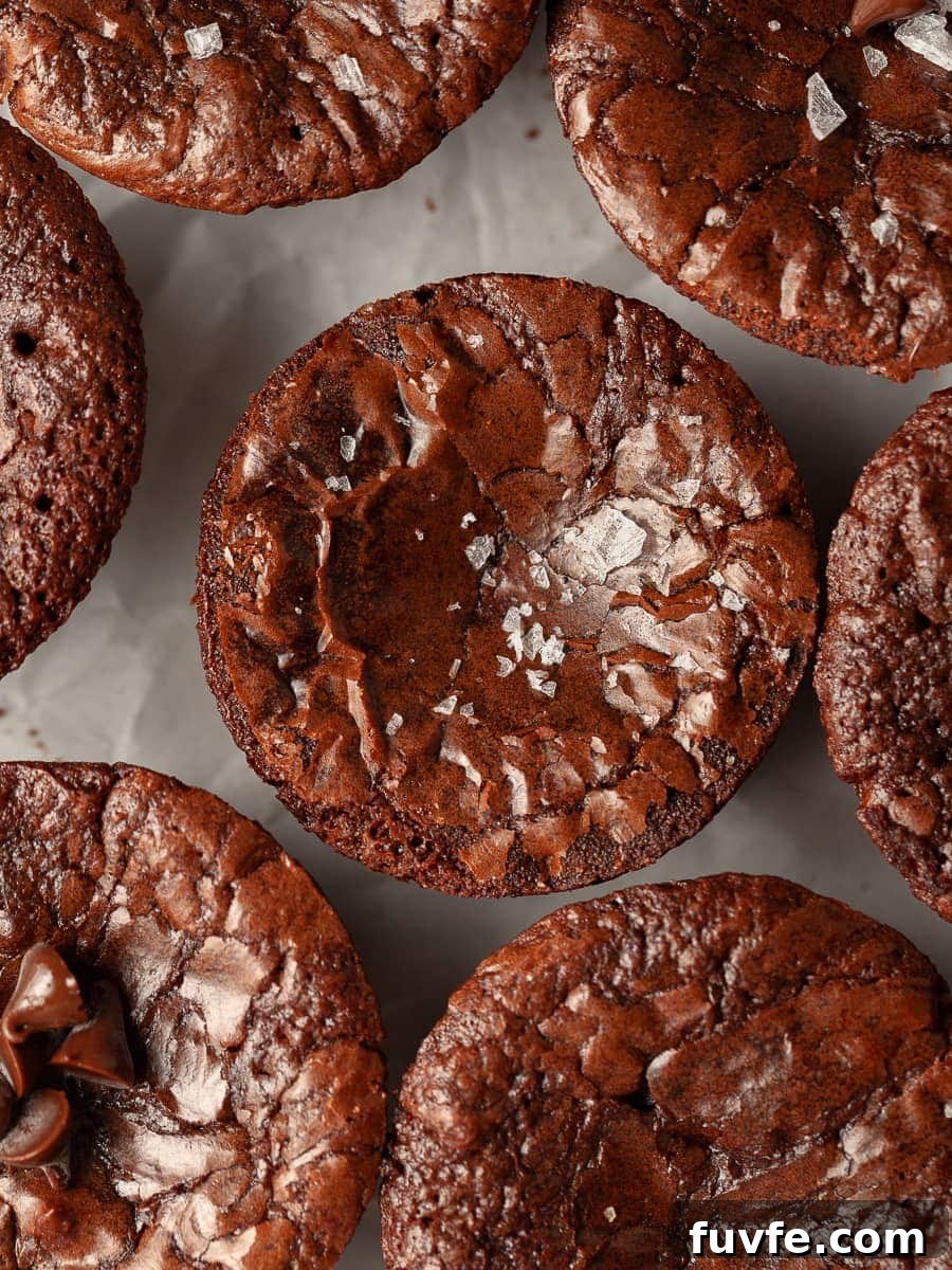 gluten free brownie bites with a crinkle crust and topped with some flaky sea salt