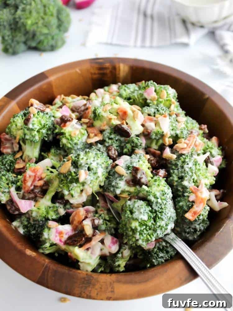 Large wood serving bowl filled with a creamy broccoli salad