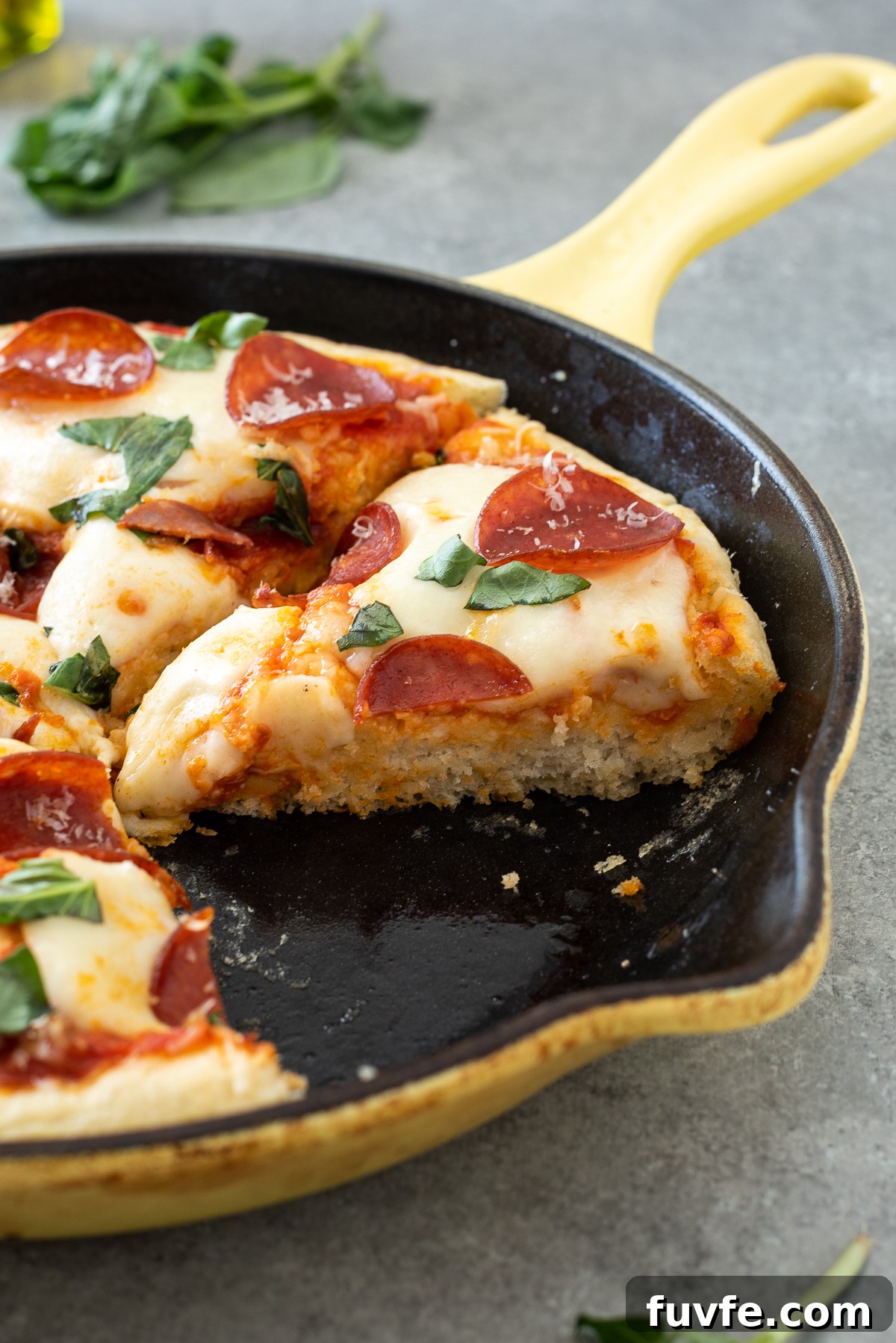 Easy focaccia pizza sliced in a cast iron skillet.
