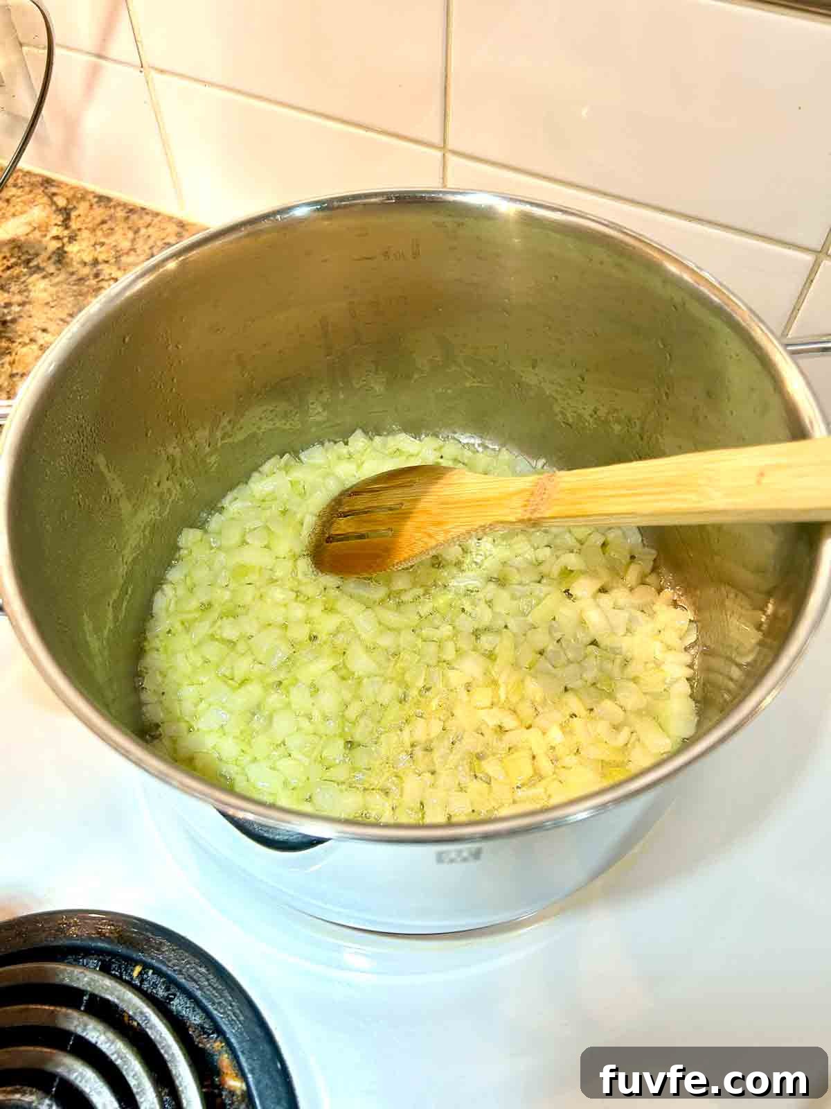 onions and garlic cooking in pot.