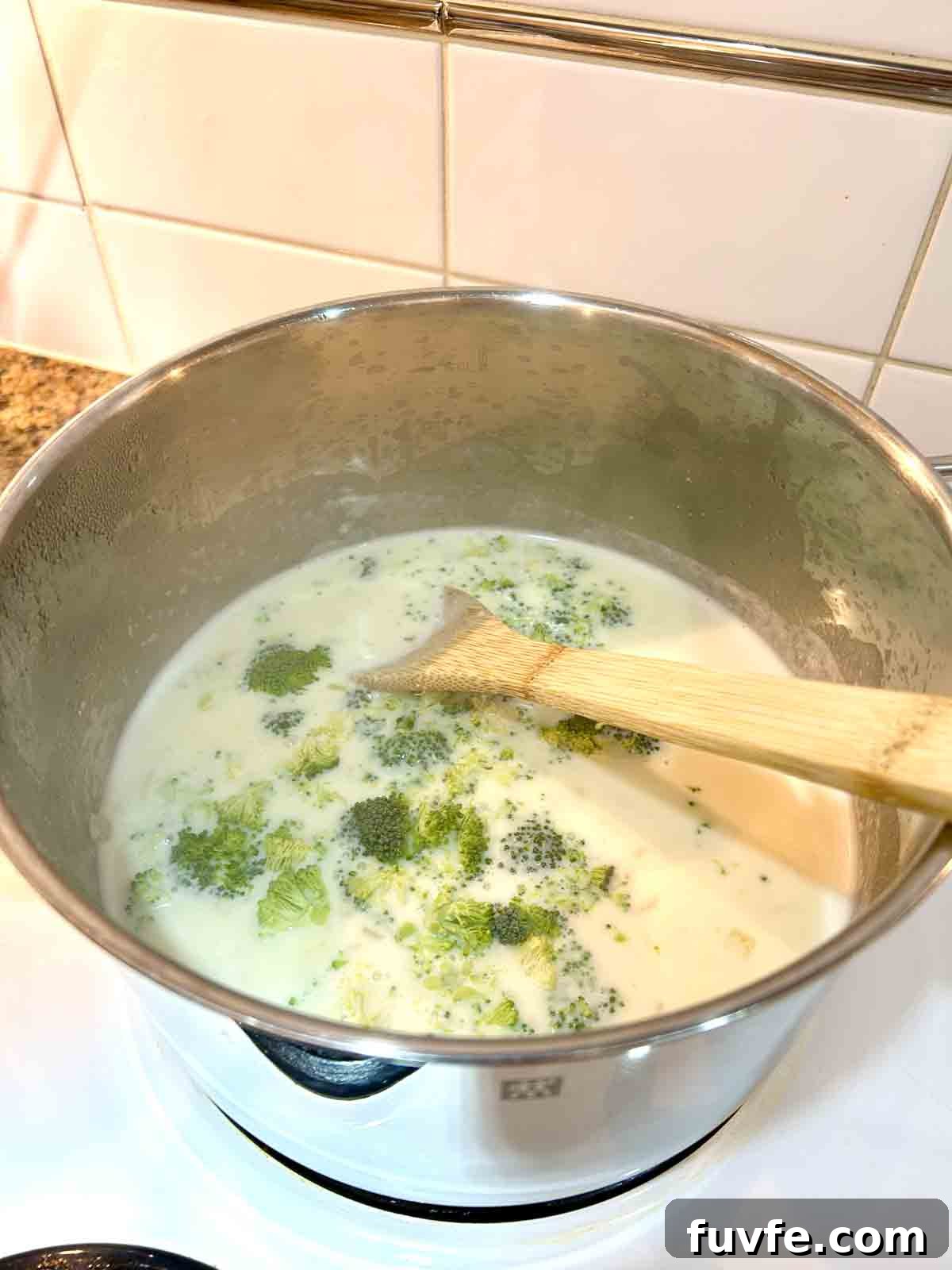 milk, chicken stock, and broccoli added to pot.