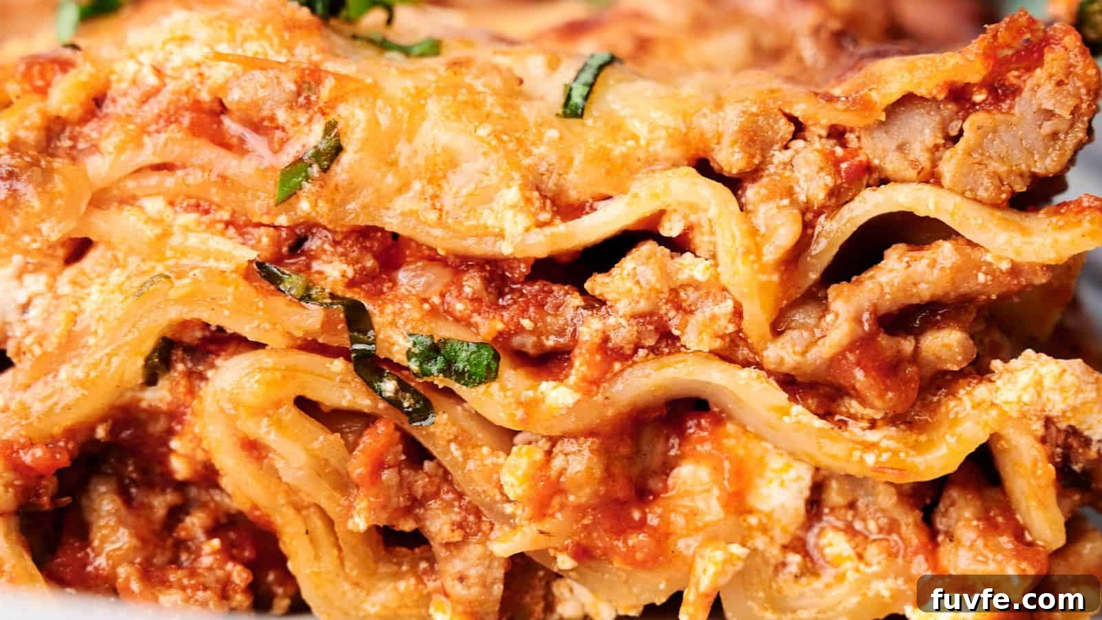 Close-up of a delicious slice of lasagna, showcasing layers of pasta, ground meat, tomato sauce, ricotta cheese, and garnished with chopped basil.
