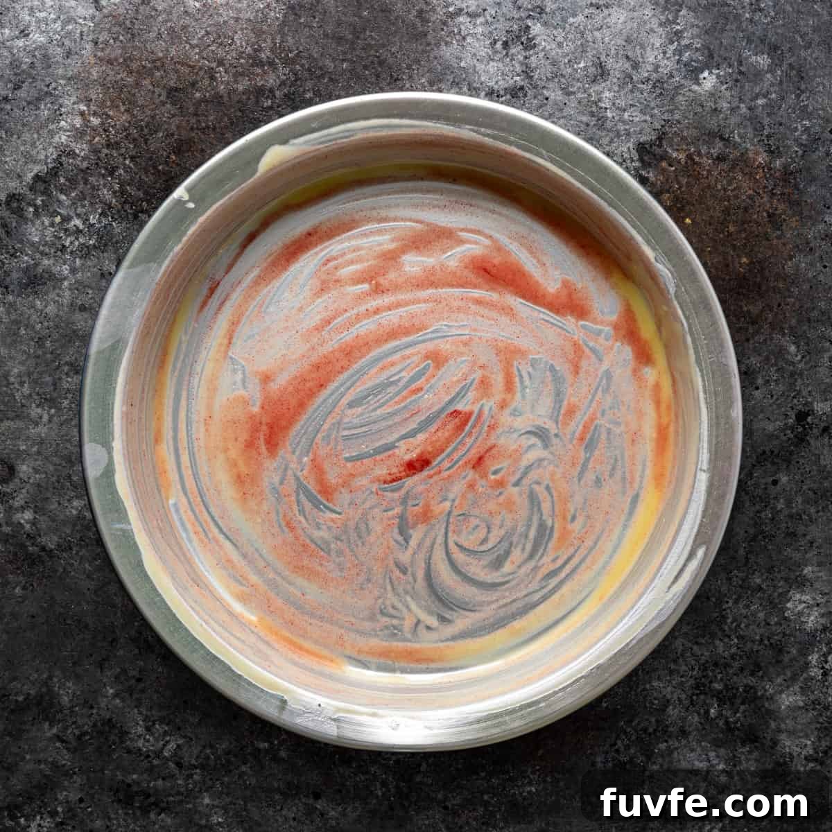 overhead: buttered 9-inch pan with pastry coloring
