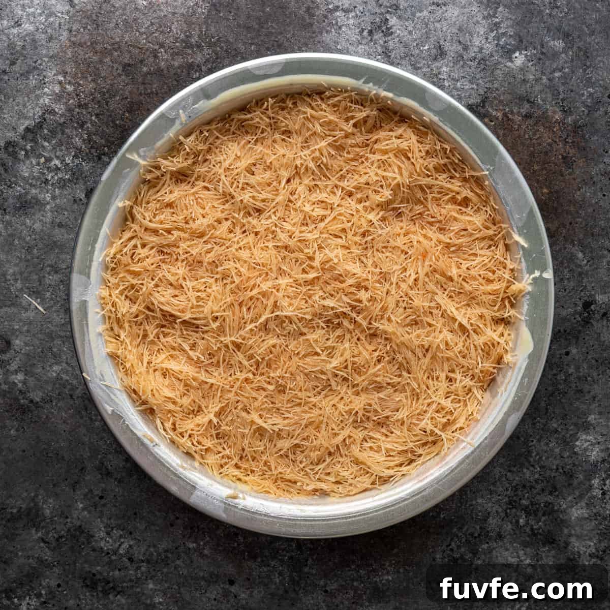 overhead: first layer of filo dough in a 9-inch pan